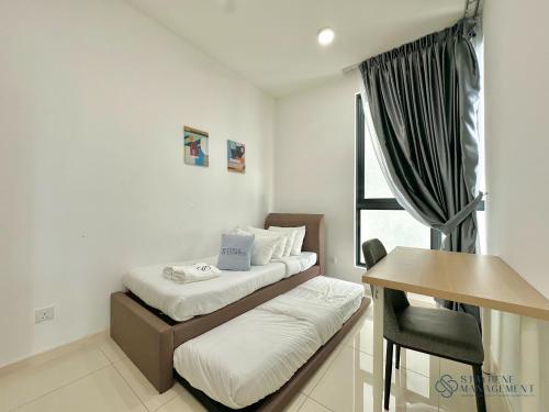 a bedroom with a bed and a desk and a table at Macrolink Medini Legoland by Stayrene in Kangkar Pendas