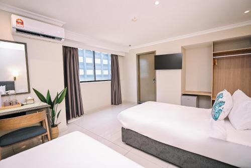 Postel nebo postele na pokoji v ubytování Kingston Hotel 6 - Changkat, Bukit Bintang