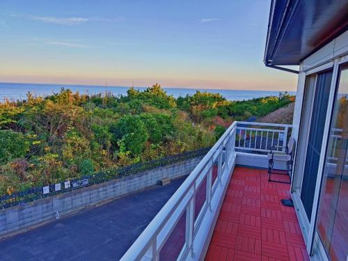 a balcony with a view of the ocean at Qiao No,105 - Vacation STAY 75661v in Hokota