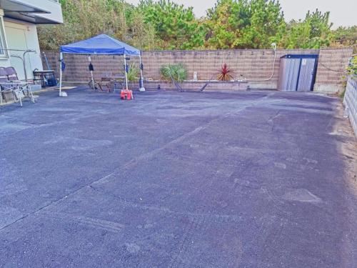 a parking lot with a blue tent in a driveway at Qiao No,105 - Vacation STAY 75661v in Hokota