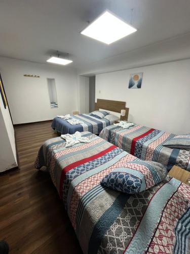 Una cama o camas en una habitación de Harmony Inn Miraflores