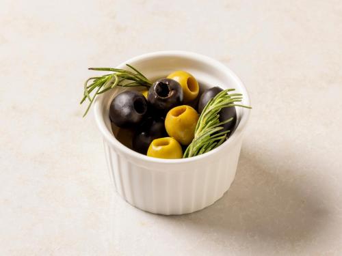 a white bowl filled with olives and rosemary at Novotel Nara in Nara