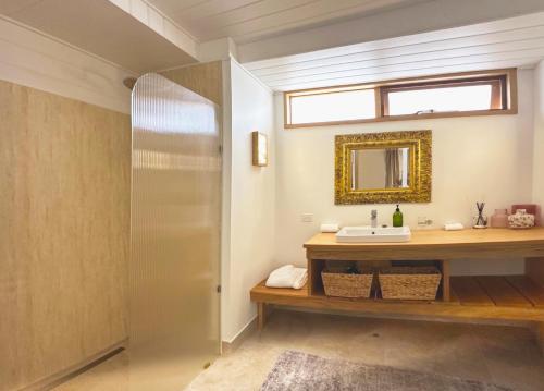 a bathroom with a sink and a mirror at Yallingup Villas in Yallingup