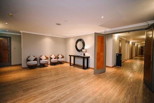 a room with couches and a table and a mirror at Kingston Hotel 11 - PWTC, KL in Kuala Lumpur