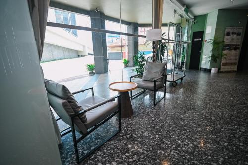 a lobby with chairs and a table in a building at Kingston Hotel 11 - PWTC, KL in Kuala Lumpur