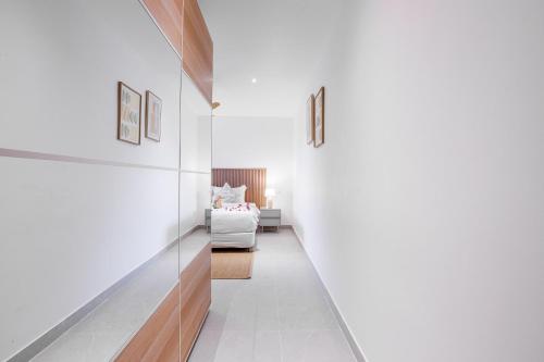 a hallway with a bed in a room at Baan Saint-Tropez Seaview Villas Kata Beach in Kata Beach