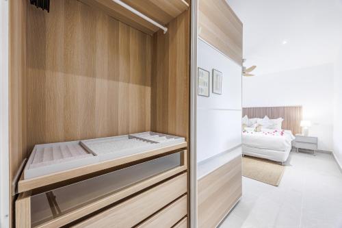 a room with a closet with a bed in it at Baan Saint-Tropez Seaview Villas Kata Beach in Kata Beach