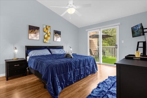 a bedroom with a bed with a blue comforter at Luxury 3BR Condo Near Disney with Pool in Kissimmee