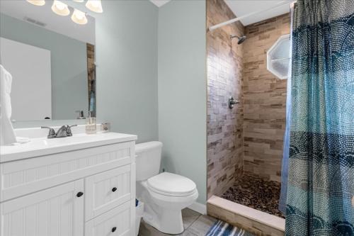 a white bathroom with a toilet and a shower at Luxury 3BR Condo Near Disney with Pool in Kissimmee