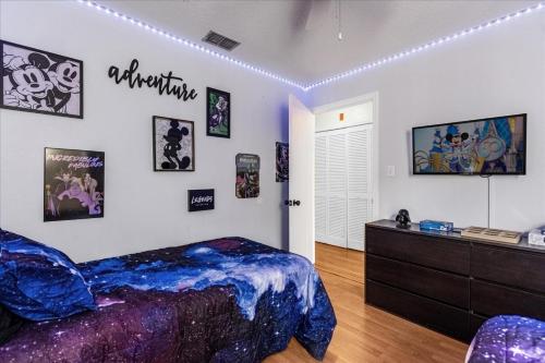 a bedroom with a bed and a dresser at Luxury 3BR Condo Near Disney with Pool in Kissimmee