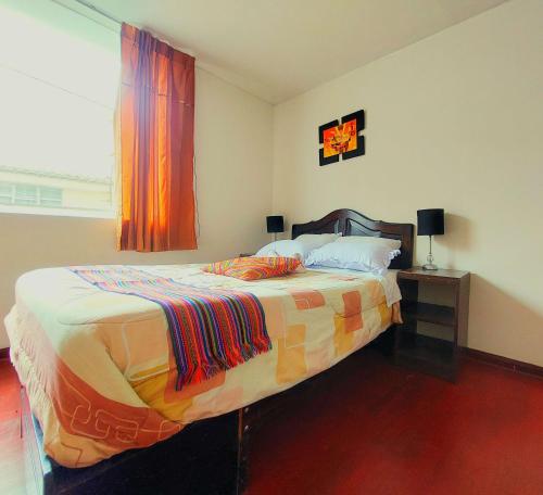 a bedroom with a bed and a window at Sumaq Wasi Caminos Del Inca in Lima