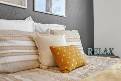 a bed with a bunch of pillows on it at Peaceful Guest Casita with Private Entrance and No Cleaning Fee in Hanford
