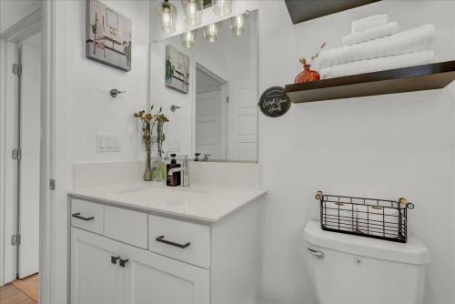 a white bathroom with a sink and a mirror at Peaceful Guest Casita with Private Entrance and No Cleaning Fee in Hanford