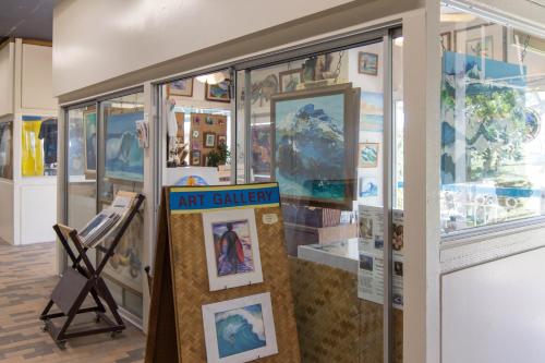 a art gallery with pictures on a wall at Waikiki Shore by OUTRIGGER in Honolulu