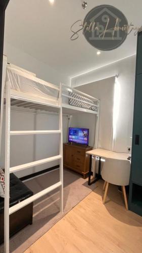 a bedroom with bunk beds and a desk and a computer at Ss Homestay By Stella Ketiau,Putatan in Kota Kinabalu
