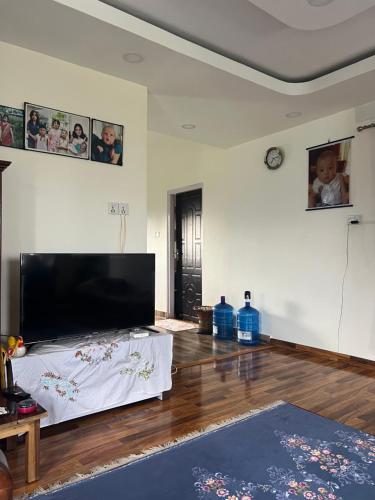 a living room with a large flat screen tv at Pokhara Residence in Rānīpauwa