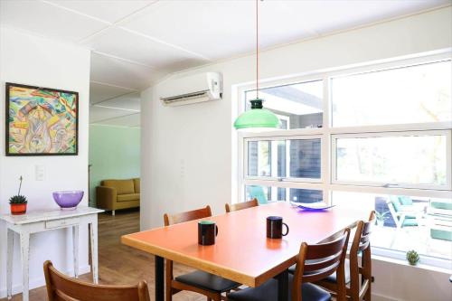 a dining room with a wooden table and chairs at 11867-Nykobing-Sj-Klintvej-112 in Klint