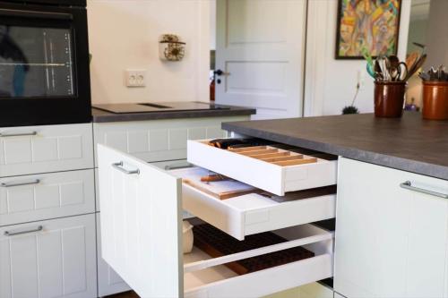 a kitchen with white cabinets and a black counter top at 11867-Nykobing-Sj-Klintvej-112 in Klint