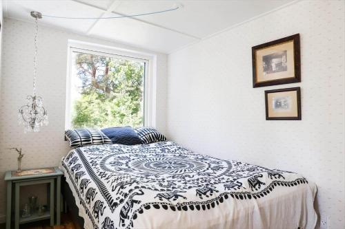 a bedroom with a black and white bed with a window at 11867-Nykobing-Sj-Klintvej-112 in Klint