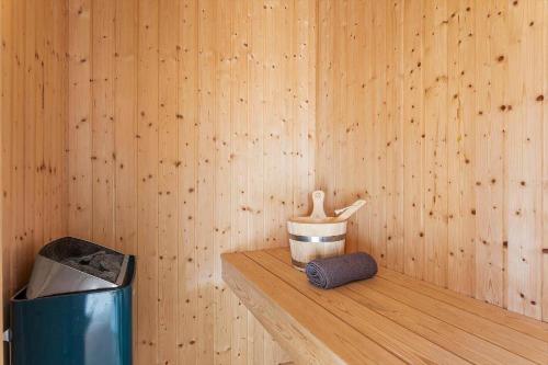 a wooden room with a wooden shelf with a container and a trash can at LK1603-Lokken-Ulstrupvej-17 in Løkken