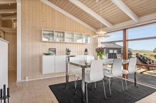 a kitchen and dining room with a table and chairs at LK1603-Lokken-Ulstrupvej-17 in Løkken