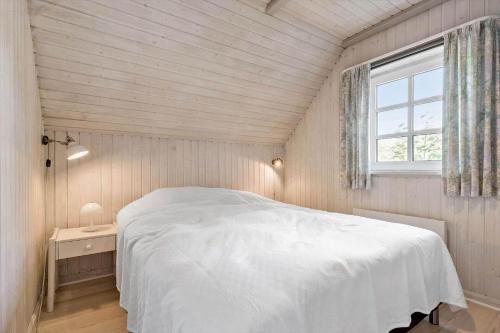 a bedroom with a white bed and a window at 84363-Knebel-Apollovej-108 in Ørby