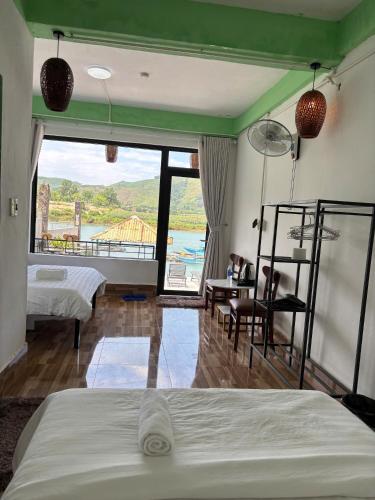 a bedroom with two beds and a view of the ocean at Horizon Homestay in Phong Nha