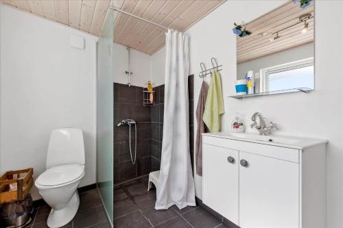 a bathroom with a shower and a toilet and a sink at 8002-Knebel-Vestre-Strandvej-39 in Knebel