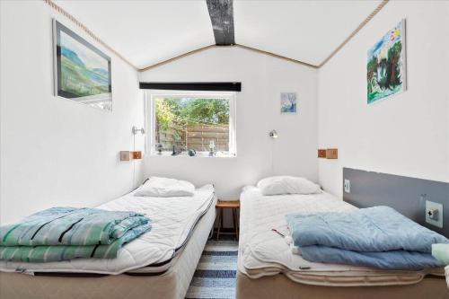 two beds in a room with two windows at 8002-Knebel-Vestre-Strandvej-39 in Knebel