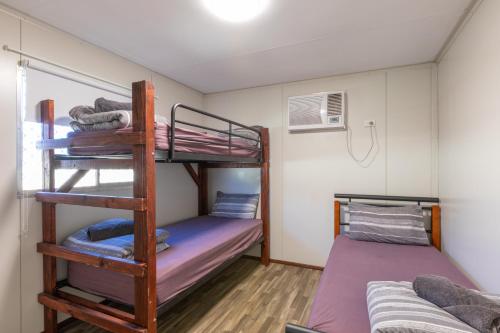 a bunk bed room with two bunk beds in it at Kalbarri Tudor Holiday Park in Kalbarri