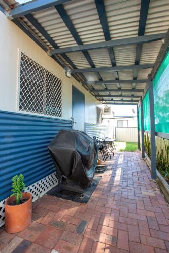 a covered patio with a black tarp on it at Kalbarri Tudor Holiday Park in Kalbarri