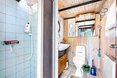 a small bathroom with a toilet and a sink at 8008-Knebel-Sletterhagevej-2 in Knebel