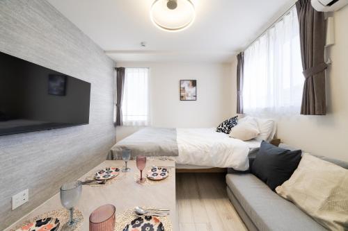 a living room with a bed and a couch at Intervia Horikiri in Tokyo