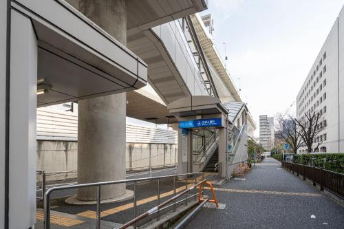 a building with a train station in a city at Haven Shibaura in Wada