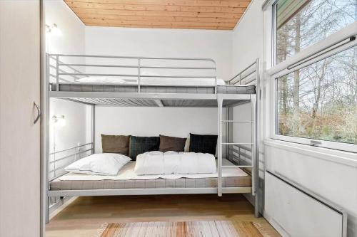a bedroom with two bunk beds in a house at 84132-Ebeltoft-Laerkevej-80 in Ebeltoft