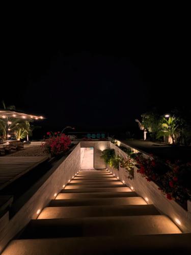 a walkway at night with lights on it at casaNorte paraíso norteño mirador de Ballenas in Canoas De Punta Sal