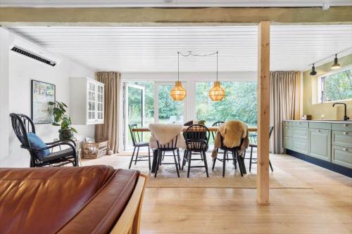 a kitchen and dining room with a table and chairs at 84127-Ebeltoft-Magevej-19 in Ebeltoft