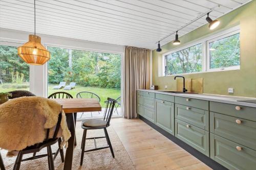 a kitchen with a wooden table and a dining room at 84127-Ebeltoft-Magevej-19 in Ebeltoft