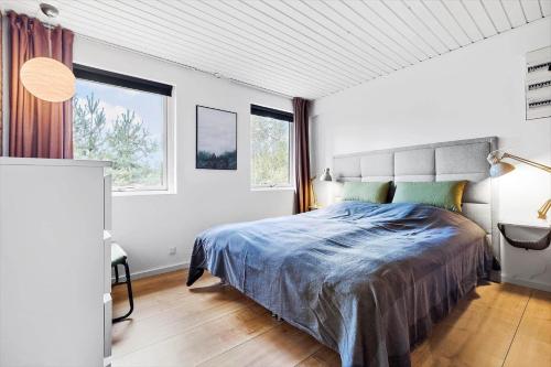 a bedroom with a bed and a large window at 84127-Ebeltoft-Magevej-19 in Ebeltoft
