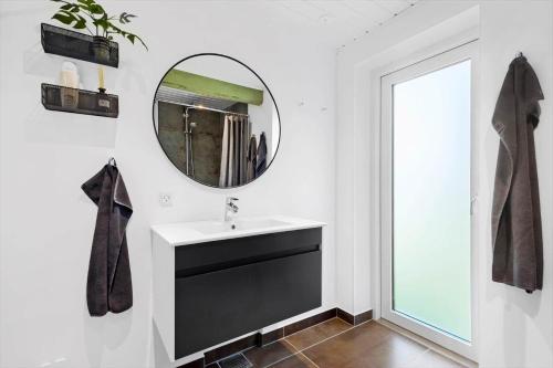 a bathroom with a sink and a mirror at 84127-Ebeltoft-Magevej-19 in Ebeltoft