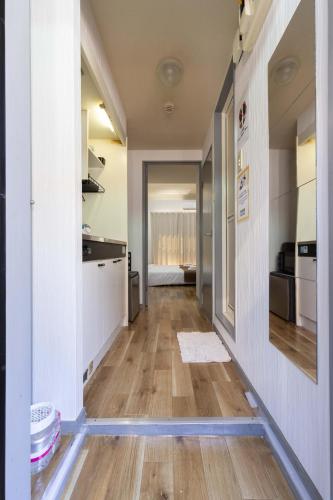 a hallway of a kitchen with a hard wood floor at Wajiro Good Place House in Fukuoka