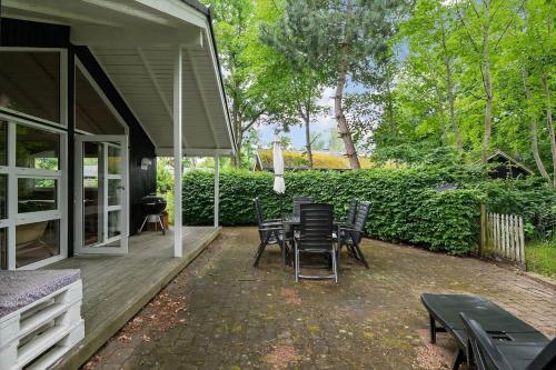 a patio with chairs and a table on a porch at 8116-Ega-Under-Ronnene-37 in Egå