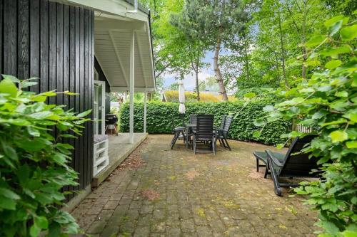 a patio with chairs and tables on a house at 8116-Ega-Under-Ronnene-37 in Egå