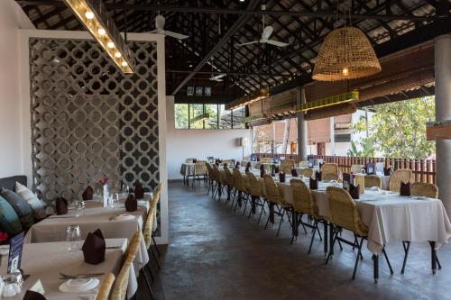 a dining room with white tables and chairs at Sala Baï Hotel & Restaurant School in Siem Reap
