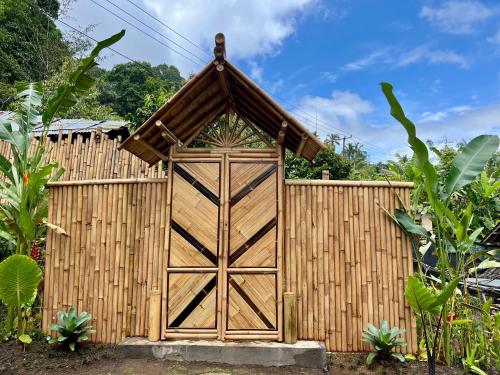 a wooden garage door with a fence at Velonia Iseh in Sidemen