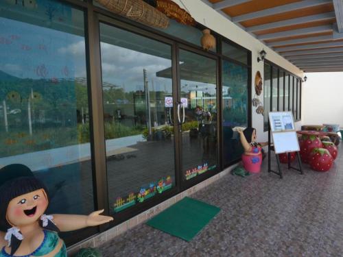 a store window with a toy doll in front of it at The Green Hotel in Ko Lipe