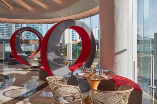 a restaurant with red and gray chairs and tables at F1 Hotel Manila in Manila