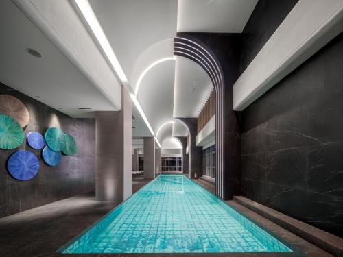 a swimming pool in the middle of a building at Novotel Xiamen Downtown in Xiamen