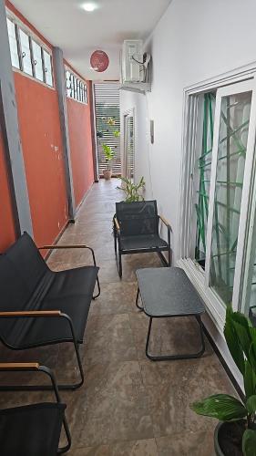 a hallway with chairs and tables in a room at Home RÉSIDENCE OUIDAH in Ouidah
