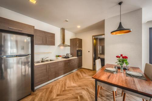 a kitchen with a wooden table and a dining room at Mansion 51 Hotel & Apartment in Phnom Penh